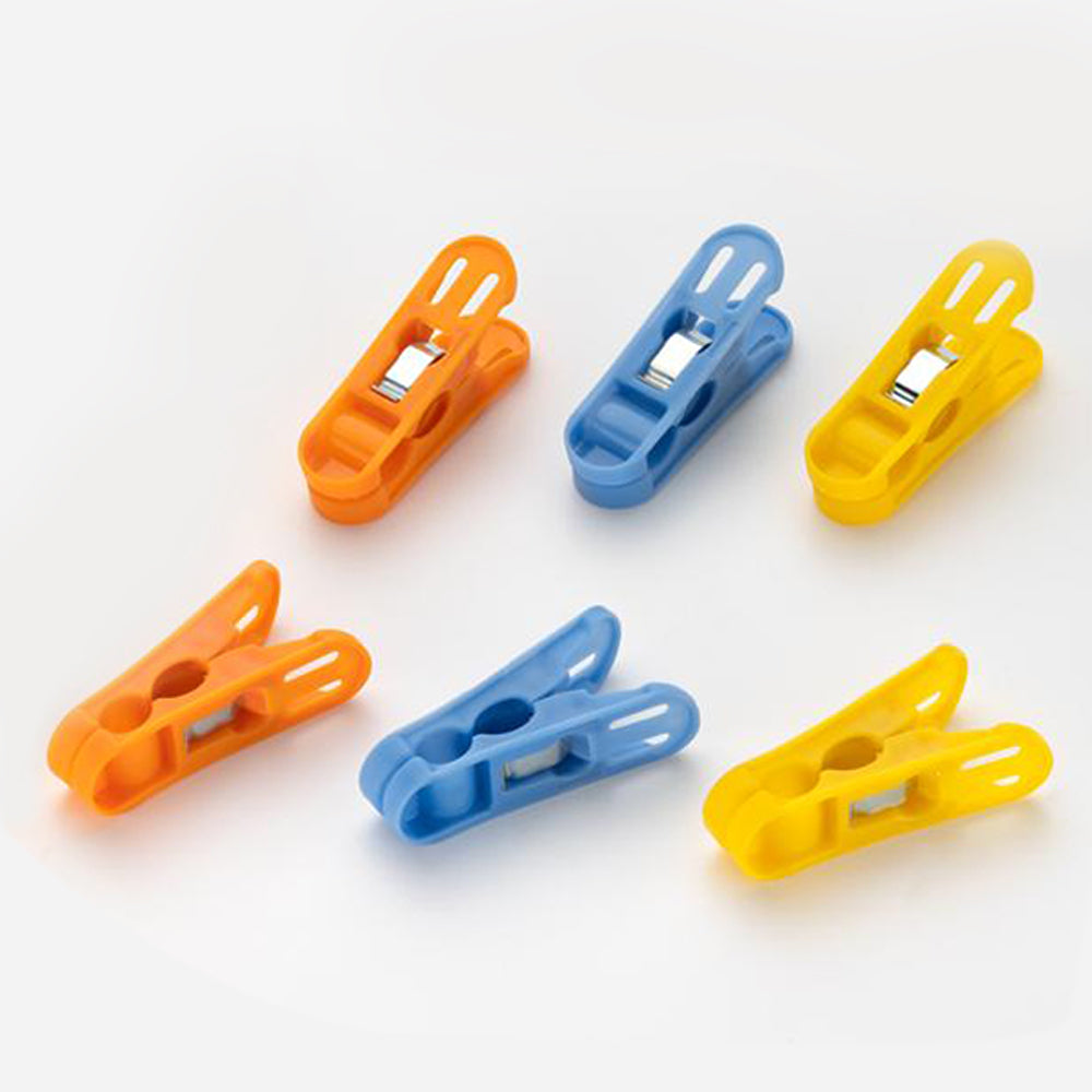 Durable non-slip plastic clips for cloth drying in bright colors.